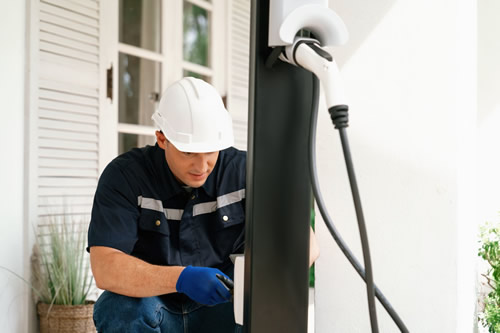 An electrician installing a car charger in a home in Georgia.